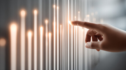 A hand swiping through virtual glowing light streaks, representing data or financial graphs.
