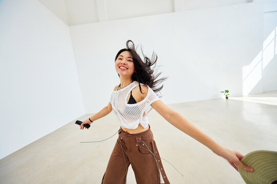 Woman enjoying dance in a bright, minimalistic studio space