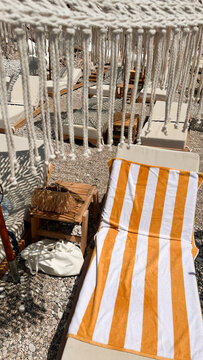Relaxing Beach Lounger with a Striped Towel
