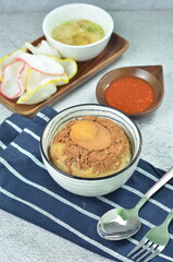 Steamed rice with chicken and egg, served with cracker and chilli,  comfort food for breakfast