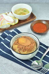 Steamed rice with chicken and egg, served with cracker and chilli,  comfort food for breakfast