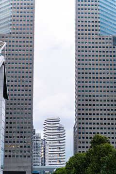 Futuristic tower between symmetrical skyscrapers