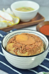 Steamed rice with chicken and egg, served with cracker and chilli,  comfort food for breakfast