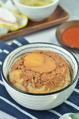 Steamed rice with chicken and egg, served with cracker and chilli,  comfort food for breakfast