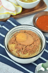 Steamed rice with chicken and egg, served with cracker and chilli,  comfort food for breakfast