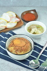 Steamed rice with chicken and egg, served with cracker and chilli,  comfort food for breakfast