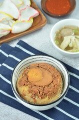 Steamed rice with chicken and egg, served with cracker and chilli,  comfort food for breakfast