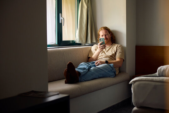 Man enjoys his time in the hotel room