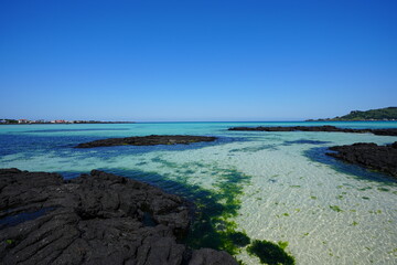 fine view with clear rock beach and far island