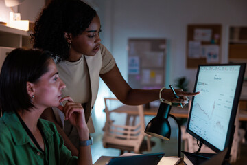 Two stock brokers analyze stock market data
