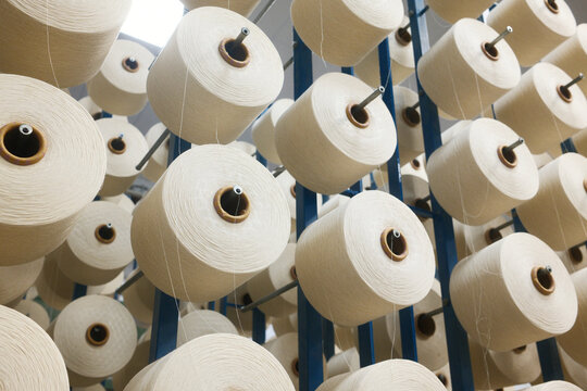 Spools of thread for weaving fabric