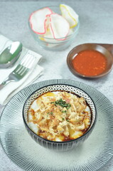 Rice porridge served with shredded with shredded Cchicken, cakwe, crackers, and chilli