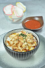 Rice porridge served with shredded with shredded Cchicken, cakwe, crackers, and chilli