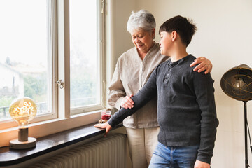 Grandmother and Grandchild Looking Out a Window Together