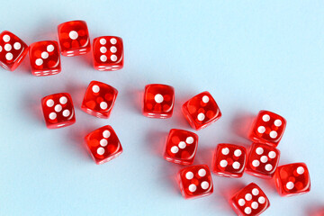 Many red game dices on blue background