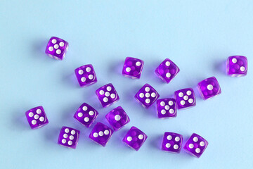 Purple game dices on blue background