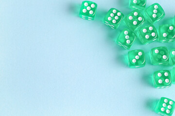 Green game dices on blue background