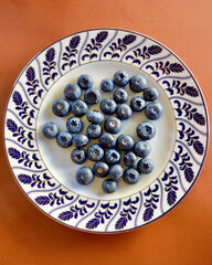 A top view of blueberries on a plate.