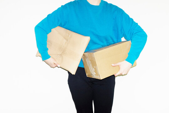 Person holding brown cardboard mail parcel package delivery boxes