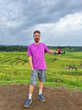Man holding FPV drone in rice terrace field