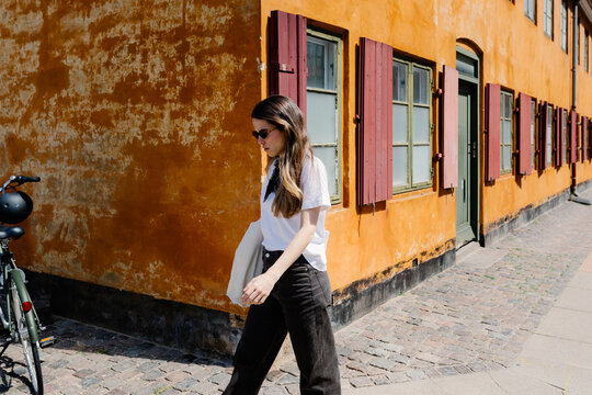 Woman strolling through the streets of the Nyboder district