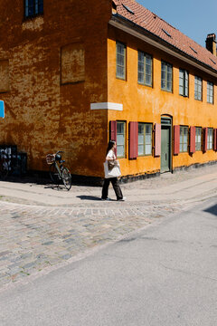 Woman walking through the peaceful streets of Nyboder
