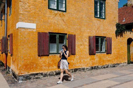 A happy traveler walking through Copenhagen&rsquo;s Nyboder district