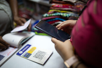 Indian woman purchasing cloths, making online payments