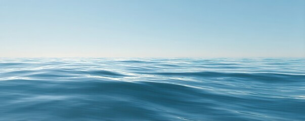 Obraz premium Calm Blue Sea with Gentle Waves under Pale Blue Sky on a Sunny Day