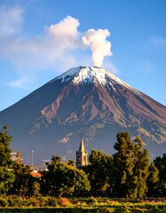 Obraz premium Volcanic mountain with smoke, town, and trees