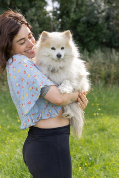 woman holding white dog