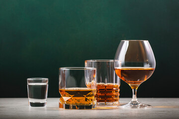 Strong alcoholic drinks set. Spirits, liqueurs, distillates etc. in glasses. Drink background banner. Hard alcohol in assortment
