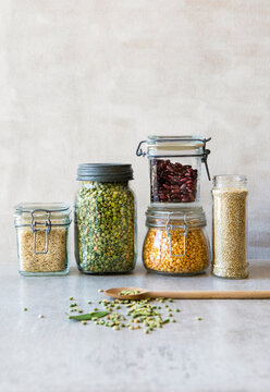Dried foods in food storage jars. Legumes beans lentils copy space