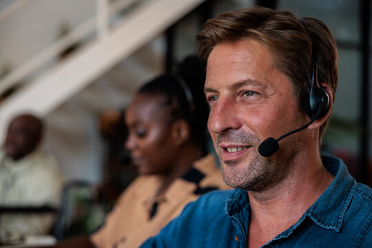Customer service representatives with headset in office