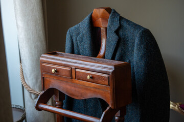 Stylish Jacket Displayed on a Wooden Rack With Drawers