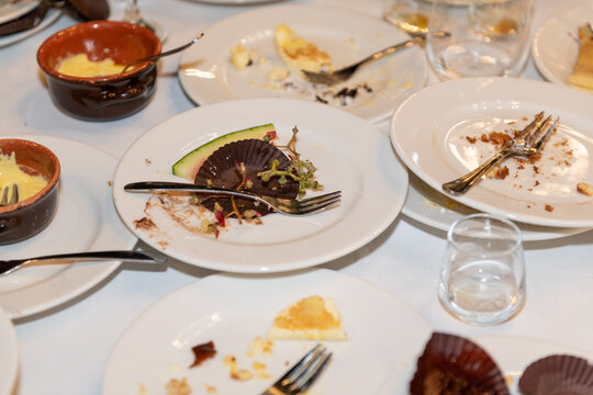 Party Aftermath With Empty Plates and Dessert Remnants