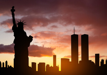 New York skyline silhouette with Towers and Statue of Liberty against the sunset
