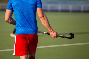 Field hockey player on artificial grass play field.