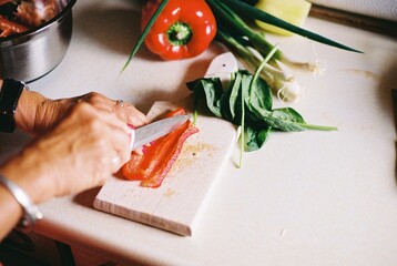 Anonymous woman chopping pepper