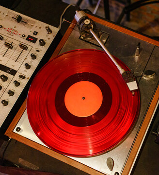 Vintage turntable Spins Vibrant Red Vinyl at a Cozy Cafe