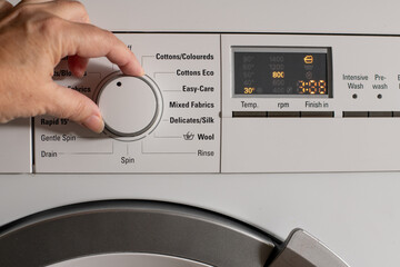 turning dial on washing machine