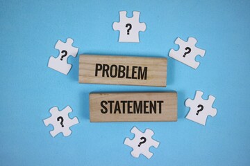 Wooden blocks with 'problem statement' written on them and a white puzzle with a question mark symbol. Problem solving concept. Isolated on an blue background.