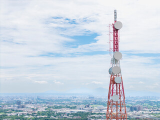 Telecommunication tower overlooking a city and mountains