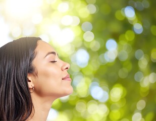 Fototapeta premium A serene woman with her eyes gently closed, tilting her head back slightly, as she gazes upward, embodying a sense of peace and tranquility.