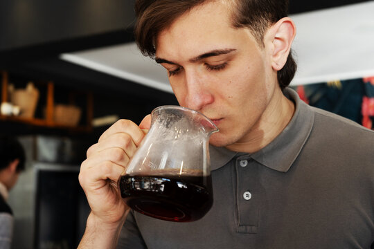 Professional barista analyzing coffee scent as part of quality check