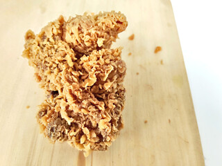 A Delicious Fried Chicken Breast on a Rustic Board