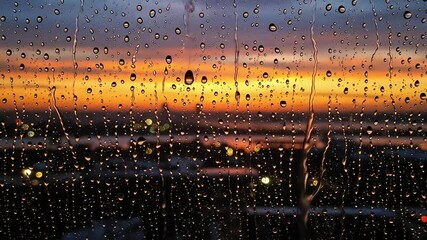 Rainy city sunset view through window - Powered by Adobe