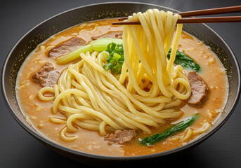 Close-up of Chopsticks Lifting Thick, Steaming Udon Noodles from a Rich, Savory Broth with Beef and Green Vegetables