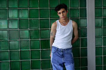 Stylish Hispanic guy standing in studio