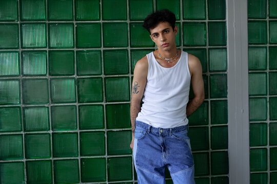 Stylish Hispanic guy standing in studio